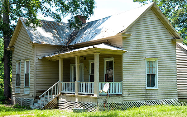 Historic Harris-Murrow-Trowell House with front porch and pale siding in Oliver, Screven County, Georgia