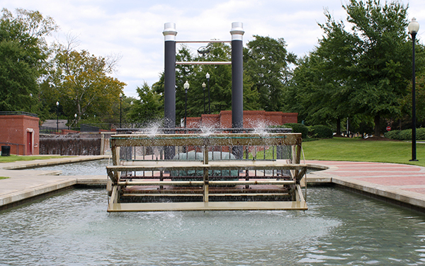 Industrial-themed fountain, paved walkways and landscaped grounds at Heritage Park in Columbus, Georgia