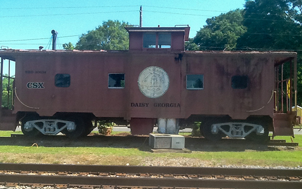 Historic railroad caboose beside the tracks in Daisy, Evans County, Georgia