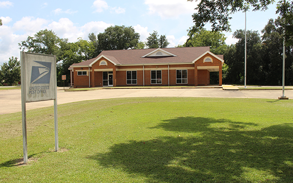 Iron City post office building with lawn and United States Postal Service sign in Seminole County, Georgia