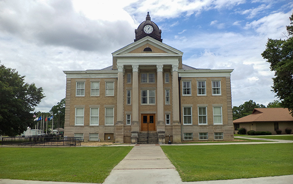 Irwin County Courthouse with clock tower and landscaped lawn in Ocilla, Georgia