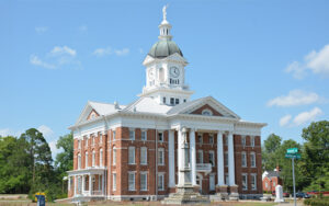 Historic red-brick Jenkins County Courthouse with clock tower in Millen, Georgia