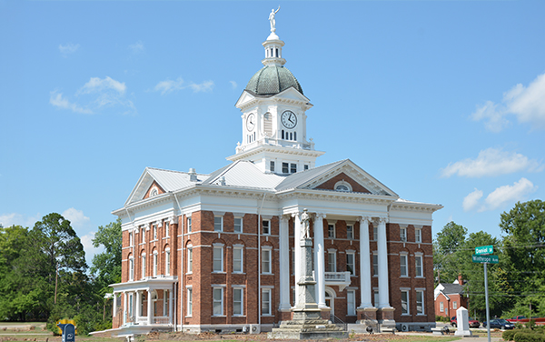 Historic red-brick Jenkins County Courthouse with clock tower in Millen, Georgia
