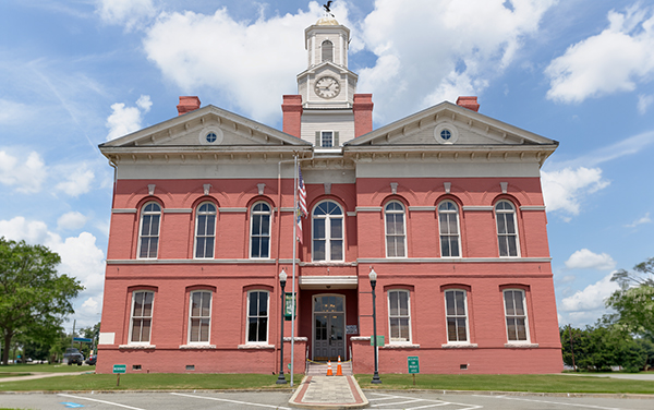 Historic red-brick Johnson County Courthouse with clock tower in Wrightsville, Georgia