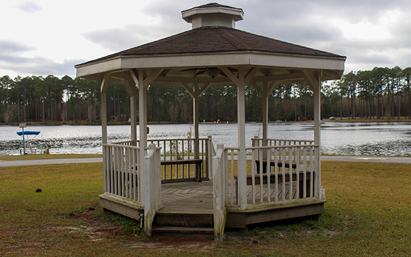 A wooden gazebo beside the lake at Laura S.
Walker State Park in Ware County, Georgia,
with pine forest across the water
