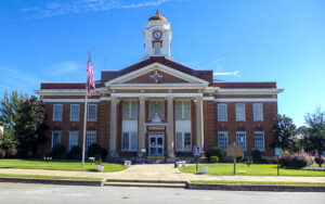 Lee County Courthouse with white columns and a clock tower in Leesburg, Georgia