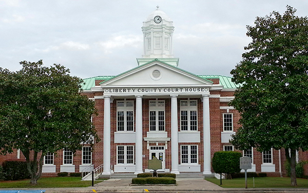 Liberty County Courthouse with white columns and a clock tower in Hinesville, Georgia