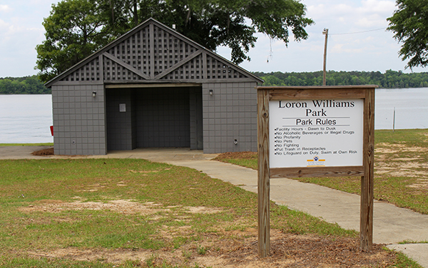 Public restroom building and park sign beside Lake Blackshear at Loron Williams Park in Crisp County, Georgia