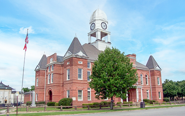 Historic red-brick Macon County Courthouse with clock tower in Oglethorpe, Georgia