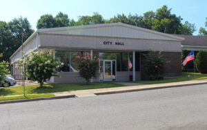 McRae-Helena City Hall building with flags and flowering trees in Telfair County, Georgia