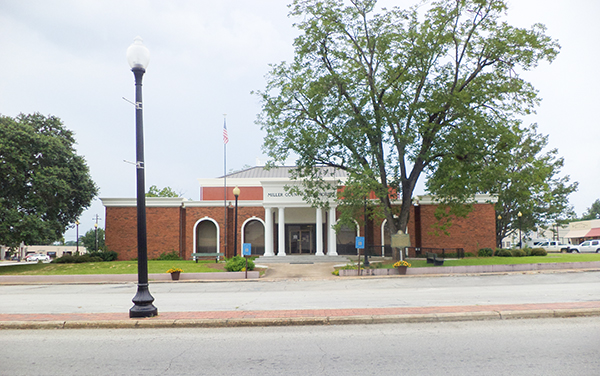 Miller County Courthouse with brick exterior, white entrance columns and landscaped grounds in Colquitt, Georgia