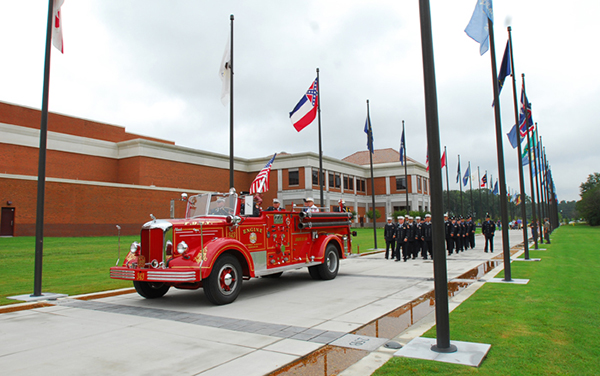 Vintage fire engine, military procession and flags along Heritage Walk outside the National Infantry Museum in Columbus, Georgia