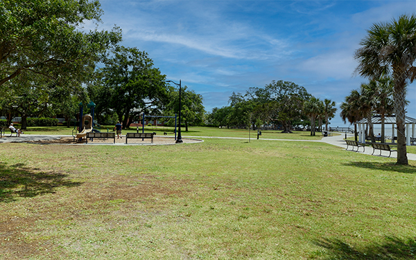 Open lawn, benches, playground and waterfront at Neptune Park on St. Simons Island, Georgia