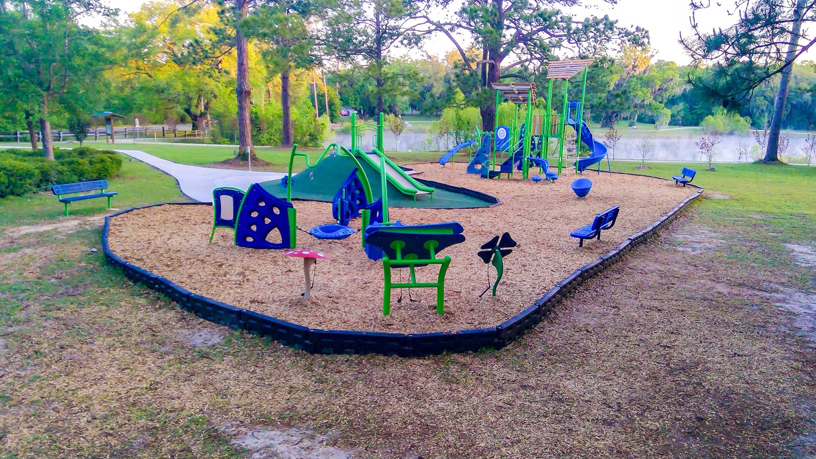 Blue and green playground beside the pond at Pedrick Pond Park in Tallahassee, Florida