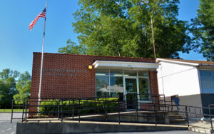 The brick United States Post Office in Preston, Georgia, the county seat of Webster County, with an American flag out front