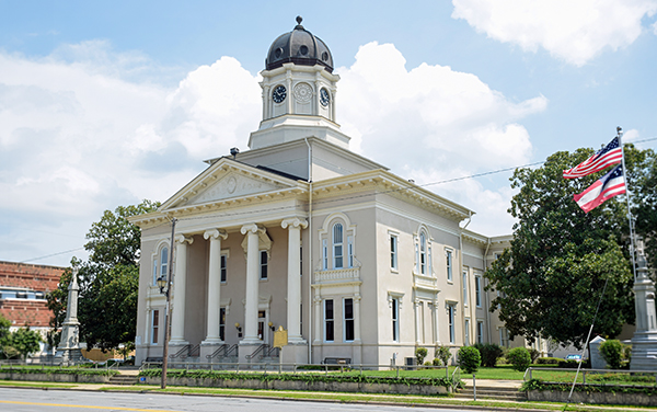 Historic Pulaski County Courthouse with columns and a clock tower in Hawkinsville, Georgia, featured by Bliss Products and Services