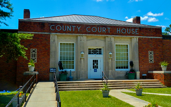 Quitman County Courthouse entrance with brick façade and front lawn in Georgetown, Georgia, featured by Bliss Products and Services