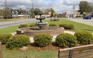 Fountain, bench and landscaped planting beds at Reidsville Garden Club Park in Tattnall County, Georgia