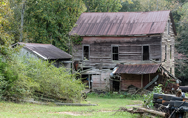The historic wooden Rose Hill Mill in Upson
County, Georgia, a weathered 19th-century
mill building set among trees