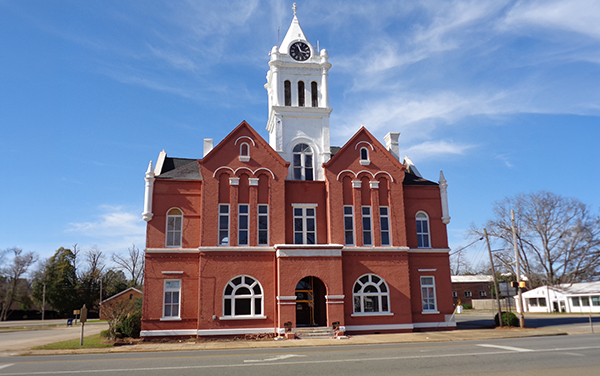 Historic Schley County Courthouse with red-brick façade and white clock tower in Ellaville, Georgia