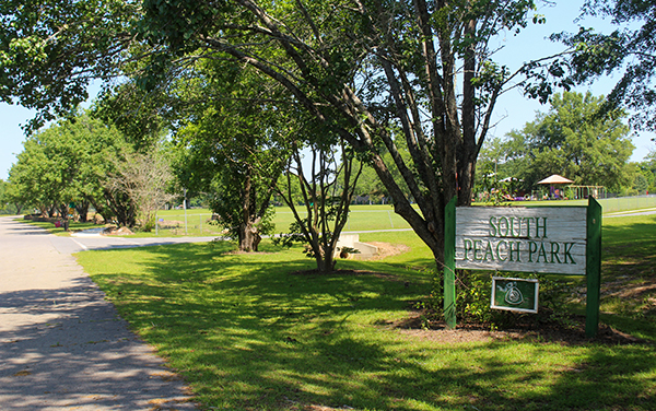 South Peach Park entrance sign, shaded lawn and recreation grounds in Fort Valley, Georgia, featured by Bliss Products and Services