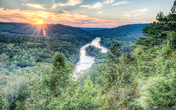 Sunset view over the Flint River winding
through the forested gorge at Sprewell
Bluff Park in Upson County, Georgia