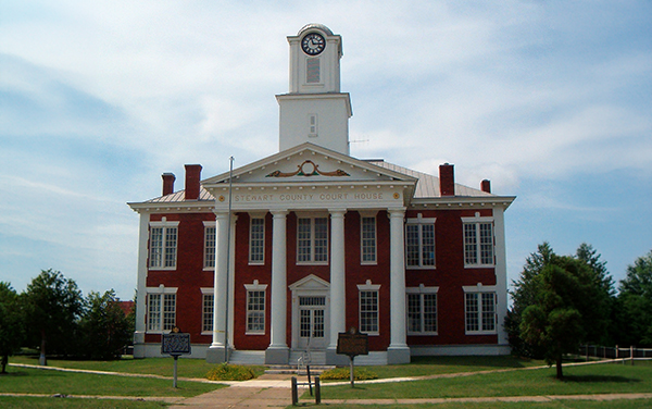 Historic Stewart County Courthouse with clock tower and columns in Lumpkin, Georgia, featured by Bliss Products and Services