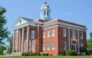 Treutlen County Courthouse with brick exterior, white columns and clock tower in Soperton, Georgia