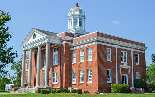 Treutlen County Courthouse with brick exterior, white columns and clock tower in Soperton, Georgia
