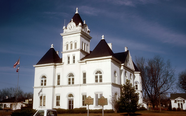 The historic Twiggs County Courthouse in
Jeffersonville, Georgia, a white
Romanesque Revival building with a clock
tower and dark turrets