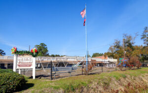 Uvalda Park entrance sign, flags and covered public structure in Uvalda, Montgomery County, Georgia