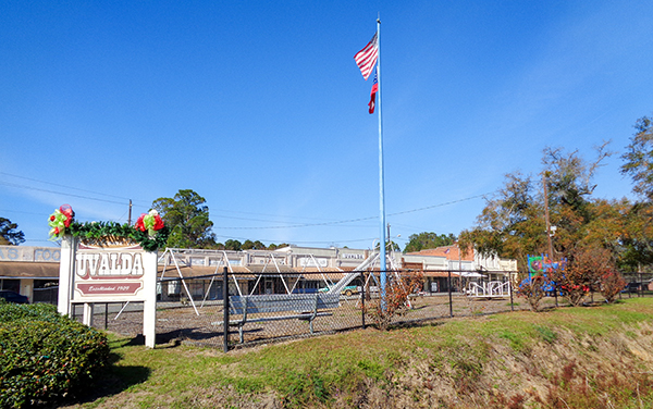 Uvalda Park entrance sign, flags and covered public structure in Uvalda, Montgomery County, Georgia