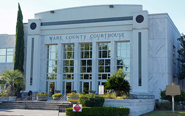 The white marble Ware County Courthouse in
Waycross, Georgia, a streamlined Art Deco
building with tall columns and the county
name engraved above the entrance