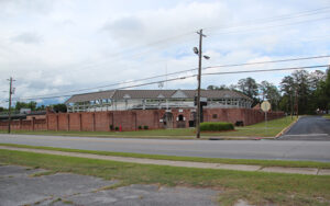 Brick-walled Brickyard stadium with spectator stands and surrounding streets in Thomson, Georgia.