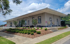 Historic Calhoun Depot with covered platform, landscaped grounds, and sidewalks in Calhoun, Georgia