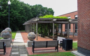 City Hall Park in Chamblee, Georgia with benches, pergola-style shade, walkway, and civic seating area