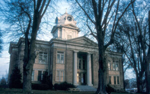 Historic Franklin County Courthouse framed by mature trees in Carnesville, Georgia