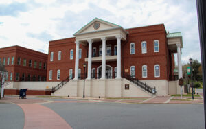 Gilmer County Courthouse with brick façade, columns, steps, and sidewalks in downtown Ellijay, Georgia