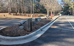 Entrance road, parking spaces, and wooded picnic area at Little Shoal Creek Public Use Area in Forsyth County, Georgia
