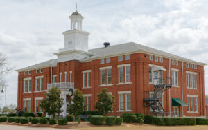 Historic red-brick Locust Grove Institute Academic Building with a central cupola in Locust Grove, Georgia.
