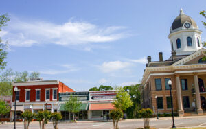 Historic storefronts and the Jasper County Courthouse around Monticello Town Square in Monticello, Georgia.