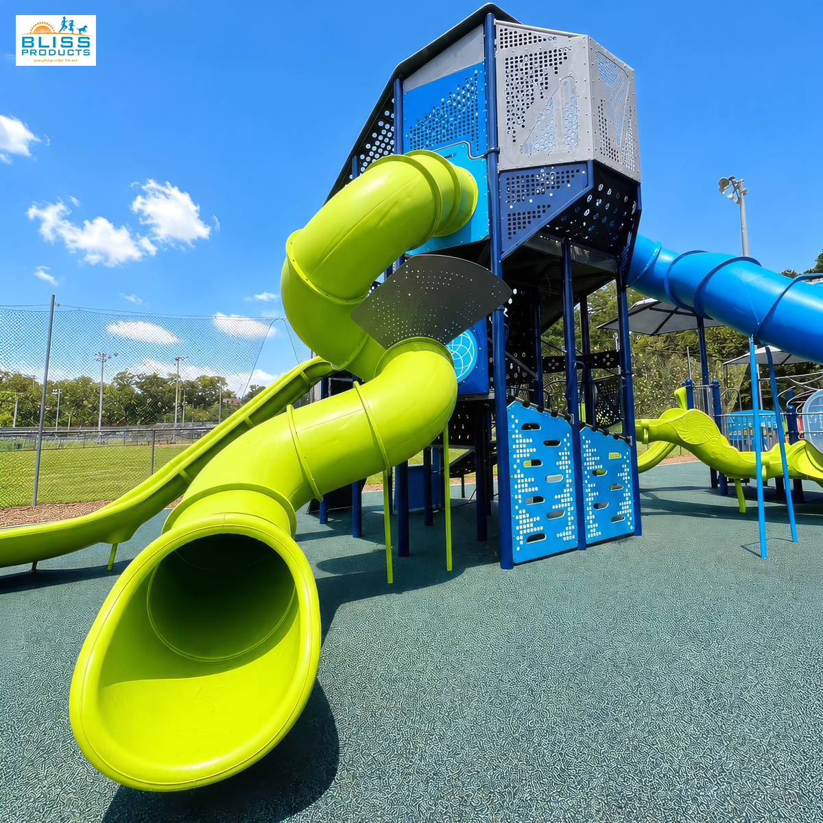 Lime-green tube slide and climbing panels on the Olympus Tower at Clay County Sports Complex in Hayesville, North Carolina.