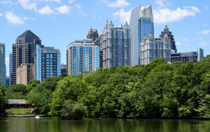 Lake Clara Meer in Piedmont Park with trees and the Midtown Atlanta skyline reflected in the water