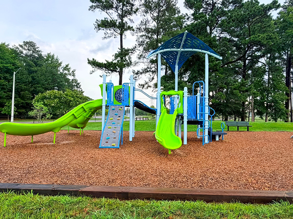 Climbing wall and lime-green slides at the Princess Anne Athletic Complex playground in Virginia Beach, Virginia