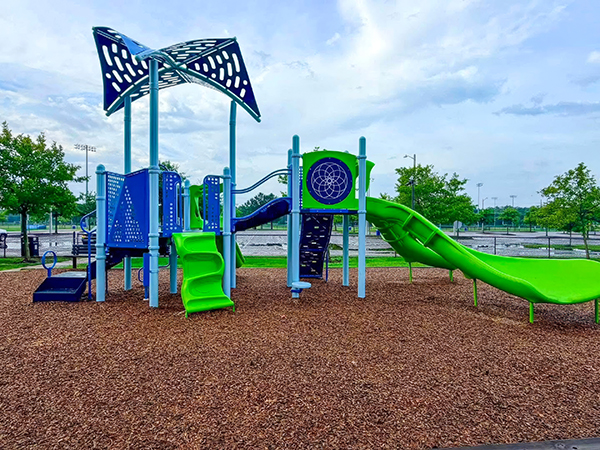 Interactive play panel and lime-green slides at the Princess Anne Athletic Complex playground in Virginia Beach, Virginia