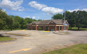 Rising Fawn, Georgia post office in Dade County, shown with parking, lawn, trees, and a small community outdoor setting.