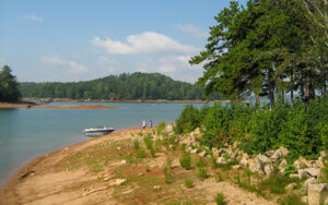 Lake Lanier shoreline, small boat, and wooded recreation area at River Forks Park in Gainesville, Georgia