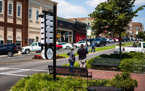 Downtown Senoia, Georgia main street with benches, sidewalks, landscaping, and local storefronts in Coweta County.