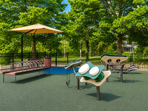 Outdoor sensory and musical play equipment beside shaded seating at Wills Memorial Park in La Plata, Maryland